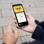 Man,In,Downtown,City,Street,Ordering,Taxi,Using,Smart,Phone